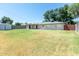 Wide backyard with grassy lawn, shed, privacy fence and mature trees at 4713 E Cambridge Ave, Phoenix, AZ 85008