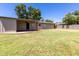 Expansive backyard featuring a lush lawn, covered patio, and mature trees, perfect for outdoor entertaining and relaxation at 4713 E Cambridge Ave, Phoenix, AZ 85008