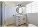 Bright bathroom featuring a granite countertop, modern lighting, and white cabinetry at 4713 E Cambridge Ave, Phoenix, AZ 85008