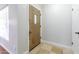 Bright entryway featuring tile floors, a decorative wood door, and white walls at 4713 E Cambridge Ave, Phoenix, AZ 85008