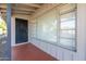 View of the covered front porch with a secure front door, a window, and neutral tones at 4713 E Cambridge Ave, Phoenix, AZ 85008