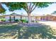 Charming single-story home with a well-manicured lawn and mature shade tree in the front yard at 4713 E Cambridge Ave, Phoenix, AZ 85008