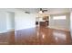 Open-concept living room with hardwood floors, light walls, and a view of the kitchen at 4713 E Cambridge Ave, Phoenix, AZ 85008