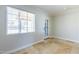 Bright room featuring tile floors, white walls, a window, and a door to the backyard at 4713 E Cambridge Ave, Phoenix, AZ 85008
