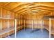 Spacious storage shed with wooden beams, concrete floor, and built-in wooden shelving for organized storage solutions at 4713 E Cambridge Ave, Phoenix, AZ 85008