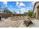 Backyard featuring desert landscaping, a custom-designed water well, and artistic decorations at 5005 E Baker Dr, Cave Creek, AZ 85331