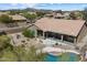 A serene backyard with a covered patio, swimming pool, and desert-style landscaping, perfect for relaxation at 5005 E Baker Dr, Cave Creek, AZ 85331