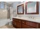 Bathroom boasts a double vanity, framed mirrors, and tiled shower over tub at 5005 E Baker Dr, Cave Creek, AZ 85331