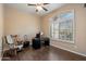 Bedroom with wood floors, ceiling fan, and large window allowing for ample natural light at 5005 E Baker Dr, Cave Creek, AZ 85331