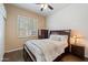 Comfortable bedroom features a ceiling fan, wood floors, and window with plantation shutters at 5005 E Baker Dr, Cave Creek, AZ 85331