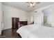 Spacious bedroom with wood-look flooring, ceiling fan, and access to the en-suite bathroom at 5005 E Baker Dr, Cave Creek, AZ 85331