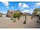 Exterior view of the backyard with desert landscaping and covered patio at 5005 E Baker Dr, Cave Creek, AZ 85331