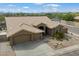 Charming single-story home featuring a tile roof, desert landscaping, and an attached two-car garage at 5005 E Baker Dr, Cave Creek, AZ 85331