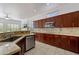 Modern kitchen showcasing granite countertops, tile flooring, stainless steel appliances and wood cabinetry at 5005 E Baker Dr, Cave Creek, AZ 85331