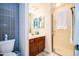 Bathroom with tile shower and sink with wooden cabinets at 5350 E Deer Valley Dr # 4239, Phoenix, AZ 85054