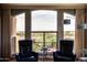 Cozy seating area with comfortable chairs and a large window overlooking a beautiful desert landscape at 5350 E Deer Valley Dr # 4239, Phoenix, AZ 85054
