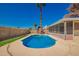 A refreshing pool stands out in the backyard, accented by a palm tree and a charming red barn-style shed at 5421 W Seldon Ln, Glendale, AZ 85302