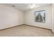 Bedroom offering neutral walls, carpet, ceiling fan and a window with neighborhood views at 5421 W Seldon Ln, Glendale, AZ 85302