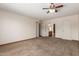 Cozy bedroom features neutral carpet, ceiling fan, and access to an attached bathroom at 5421 W Seldon Ln, Glendale, AZ 85302