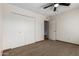 Bedroom boasts neutral walls and carpet, a ceiling fan, and closet at 5421 W Seldon Ln, Glendale, AZ 85302