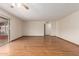 Large living room features hardwood floors, a ceiling fan, and access to the backyard through sliding doors at 5421 W Seldon Ln, Glendale, AZ 85302