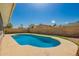 The refreshing blue swimming pool provides a tranquil backyard oasis, framed by lush green grass and a high block wall at 5421 W Seldon Ln, Glendale, AZ 85302