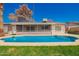 A well-maintained pool is nestled in a backyard with green grass and mature landscaping, perfect for relaxation at 5421 W Seldon Ln, Glendale, AZ 85302