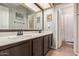Bathroom featuring dual sinks and neutral tones at 5428 W Wethersfield Dr, Glendale, AZ 85304