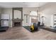 Spacious home gym with fireplace, hardwood floors, and state-of-the-art fitness equipment at 5428 W Wethersfield Dr, Glendale, AZ 85304