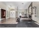 Spacious home gym with fireplace, hardwood floors, and state-of-the-art fitness equipment at 5428 W Wethersfield Dr, Glendale, AZ 85304