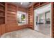Spacious office with custom built-in shelving and large windows, with an open doorway to the living room at 5428 W Wethersfield Dr, Glendale, AZ 85304