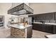 Kitchen features stainless steel appliances, dark cabinetry, a stylish backsplash, and a functional kitchen island at 5428 W Wethersfield Dr, Glendale, AZ 85304