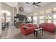 Bright living room showcasing vaulted ceilings, wood floors, and a stylish kitchen view, perfect for entertaining at 5428 W Wethersfield Dr, Glendale, AZ 85304