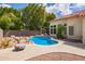 Lush backyard featuring a beautiful blue pool with rock accents and a cozy patio area, perfect for relaxation at 5428 W Wethersfield Dr, Glendale, AZ 85304