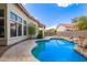 Beautiful backyard pool with a stone patio offers a tranquil retreat for relaxation and outdoor enjoyment at 5428 W Wethersfield Dr, Glendale, AZ 85304