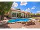 A sparkling blue pool with stone accents enhances the outdoor living space of this beautiful property at 5428 W Wethersfield Dr, Glendale, AZ 85304