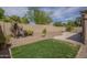 Lush backyard with grassy area, desert landscaping, and a beautiful swimming pool at 5900 W Orchid Ln, Chandler, AZ 85226