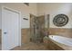 Well-lit bathroom showing shower, tub, and door at 5900 W Orchid Ln, Chandler, AZ 85226