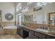 Bathroom featuring dual vanities, and a separate shower stall and bath tub at 5900 W Orchid Ln, Chandler, AZ 85226