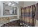 Bathroom featuring granite countertops, designer lighting, tile wainscoting, and glass enclosed shower at 5900 W Orchid Ln, Chandler, AZ 85226