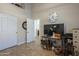 Bonus room with vaulted ceiling, closet, and doorway; featuring large clock and modern media center at 5900 W Orchid Ln, Chandler, AZ 85226