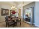 Dining room with chandelier, tile floor, and large framed mirror at 5900 W Orchid Ln, Chandler, AZ 85226