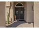 Close-up of an arched front door, featuring decorative ironwork and stylish 'Welcome' decor at 5900 W Orchid Ln, Chandler, AZ 85226