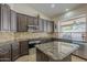 Kitchen features granite countertops, backsplash and stainless steel appliances at 5900 W Orchid Ln, Chandler, AZ 85226