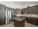 Modern kitchen with stainless appliances, granite counters, and custom cabinets at 5900 W Orchid Ln, Chandler, AZ 85226