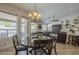Open-concept living room with dining area featuring sliding glass doors and a comfortable seating area at 5900 W Orchid Ln, Chandler, AZ 85226