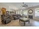 Open-concept living room with comfortable seating, tile floors, and bright natural light at 5900 W Orchid Ln, Chandler, AZ 85226