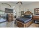 Spacious primary bedroom featuring dark wood furnishings and en-suite bath with a large mirror at 5900 W Orchid Ln, Chandler, AZ 85226