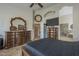 Primary bedroom with dual dressers, television and en-suite bathroom with glass shower stall at 5900 W Orchid Ln, Chandler, AZ 85226