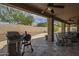 Outdoor patio area featuring a grill, ceiling fans, and view of the pool at 5900 W Orchid Ln, Chandler, AZ 85226